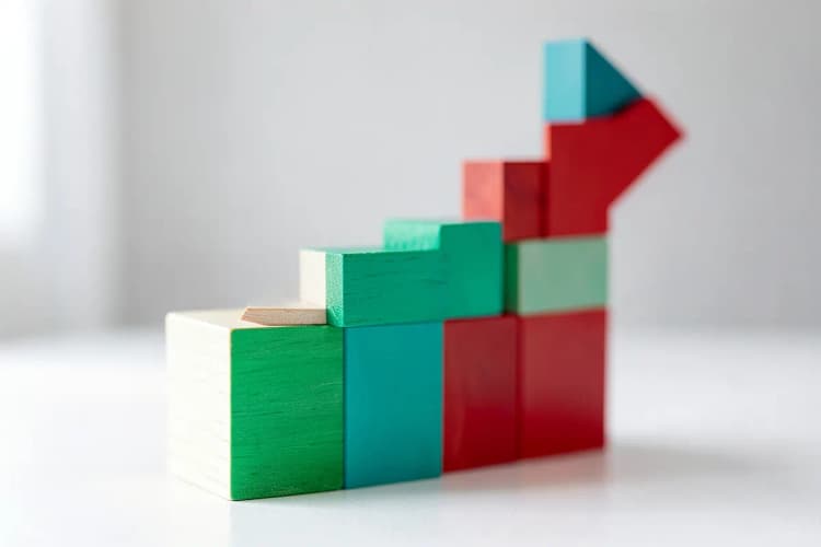 Um gráfico de barras ascendente feito de blocos de madeira, simbolizando o crescimento e os benefícios de negócios.